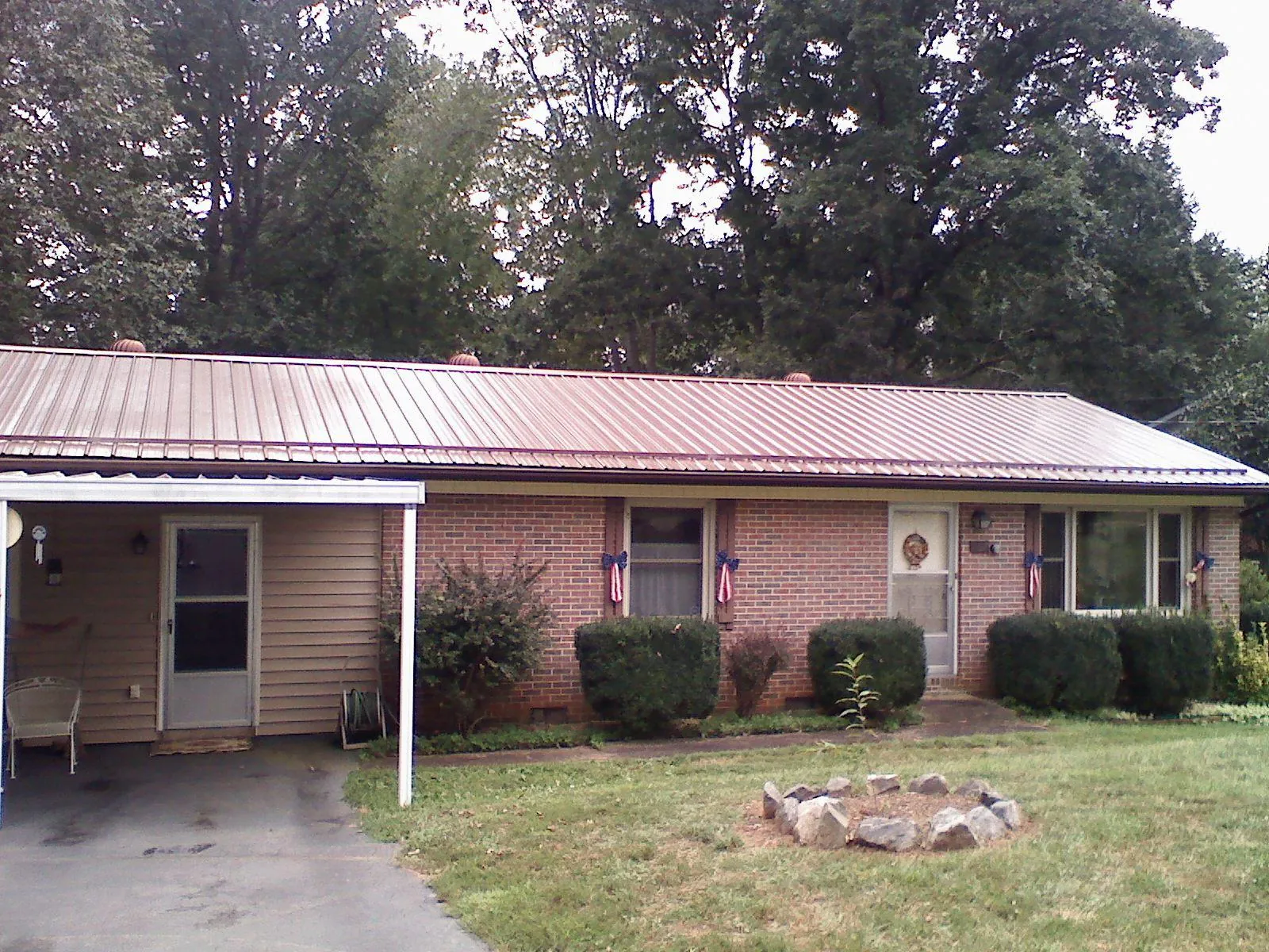 Bronze metal roof and carport on a brick ranch home — Roof Repair work by our crew in River Grove