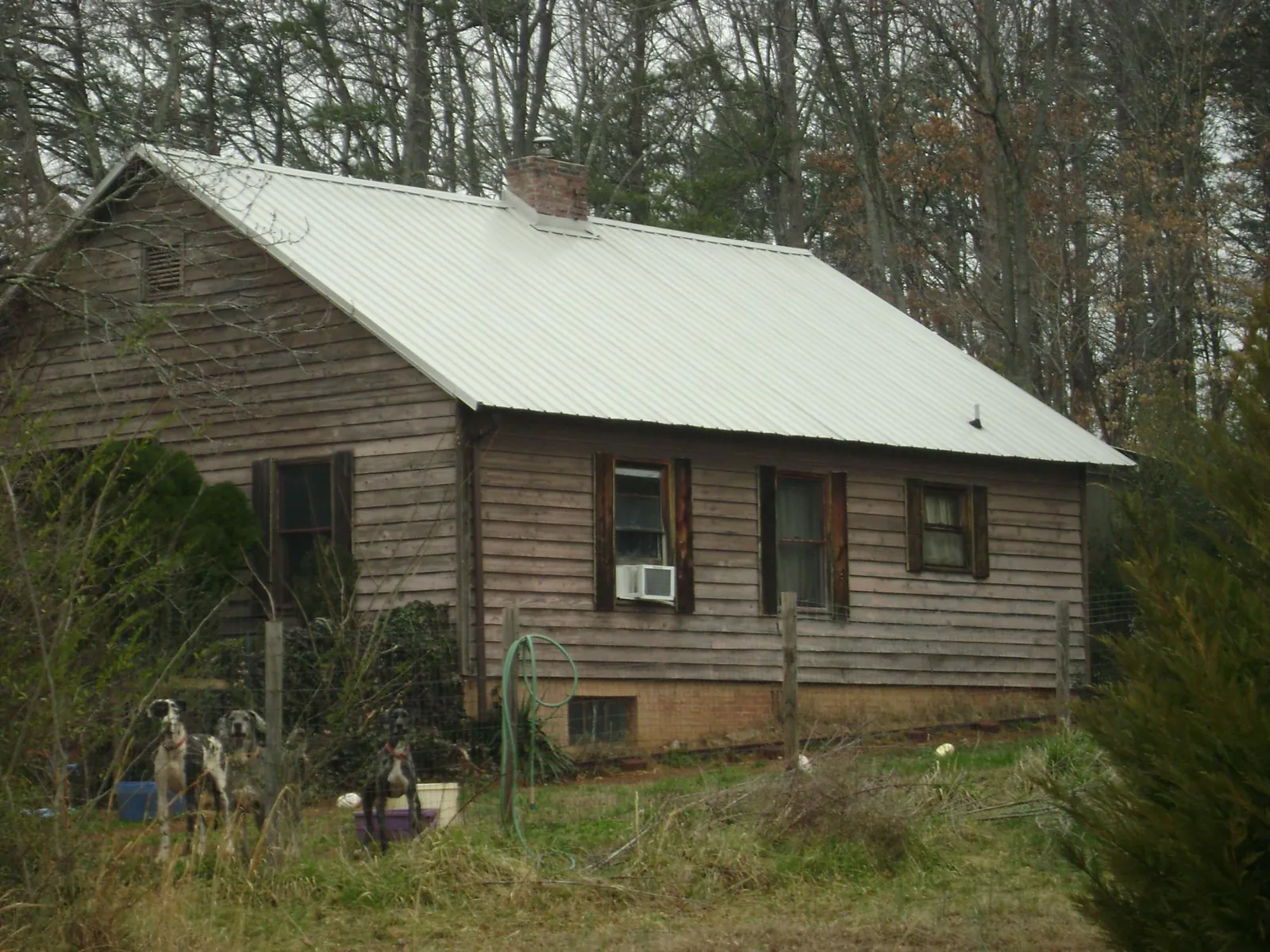 White metal roof on an old wood sided farmhouse, from a Metal Roof Installation job in River Grove